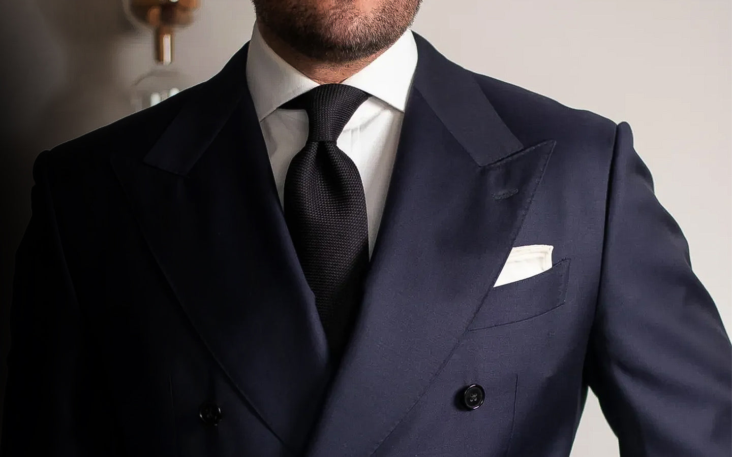 Armando Madrid in wearing a Black Grenadine Tie & White Pocket Square