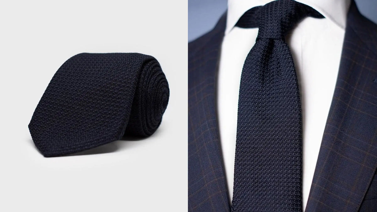 Navy grenadine tie shown rolled, and knotted with a navy check jacket