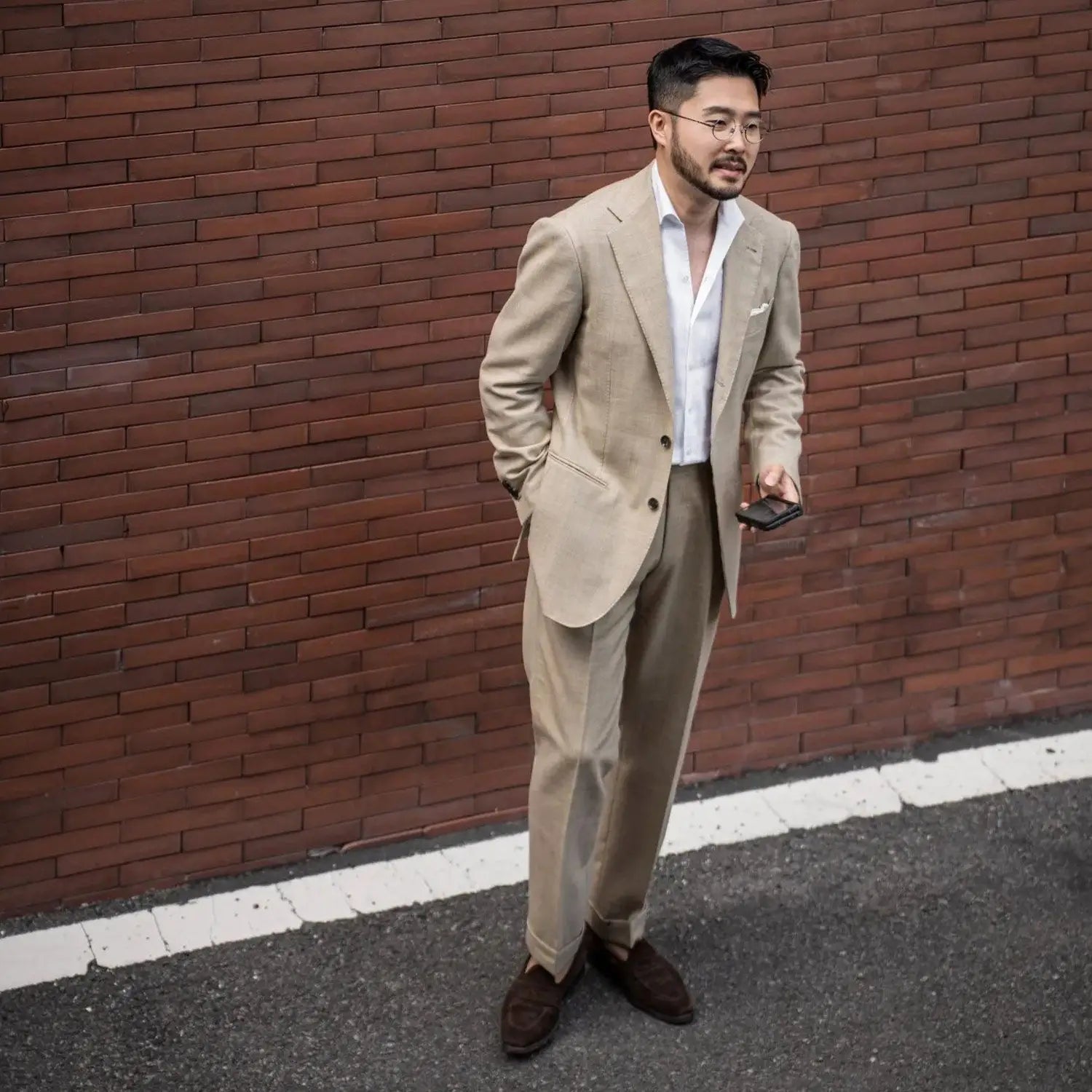 Man in tan suit showcasing stylish office outfits to stay cool at the office