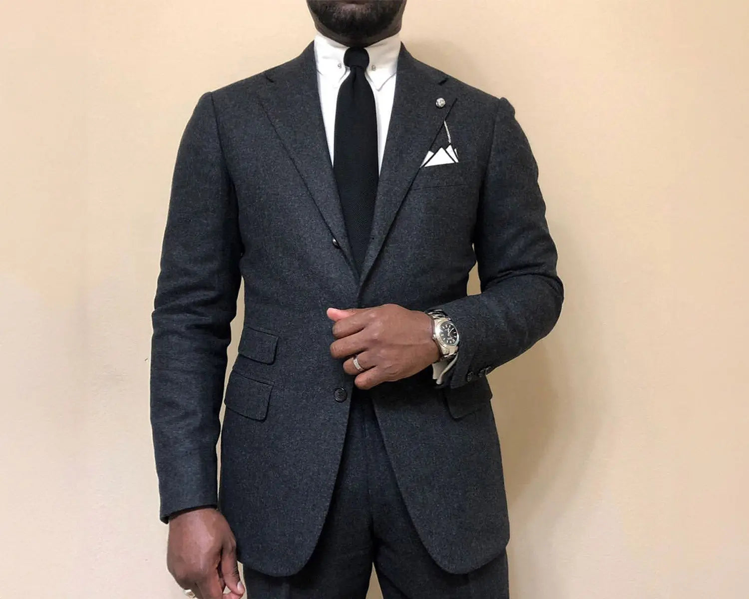 Man in a dark wedding suit and dress shirt for a stylish wedding day look