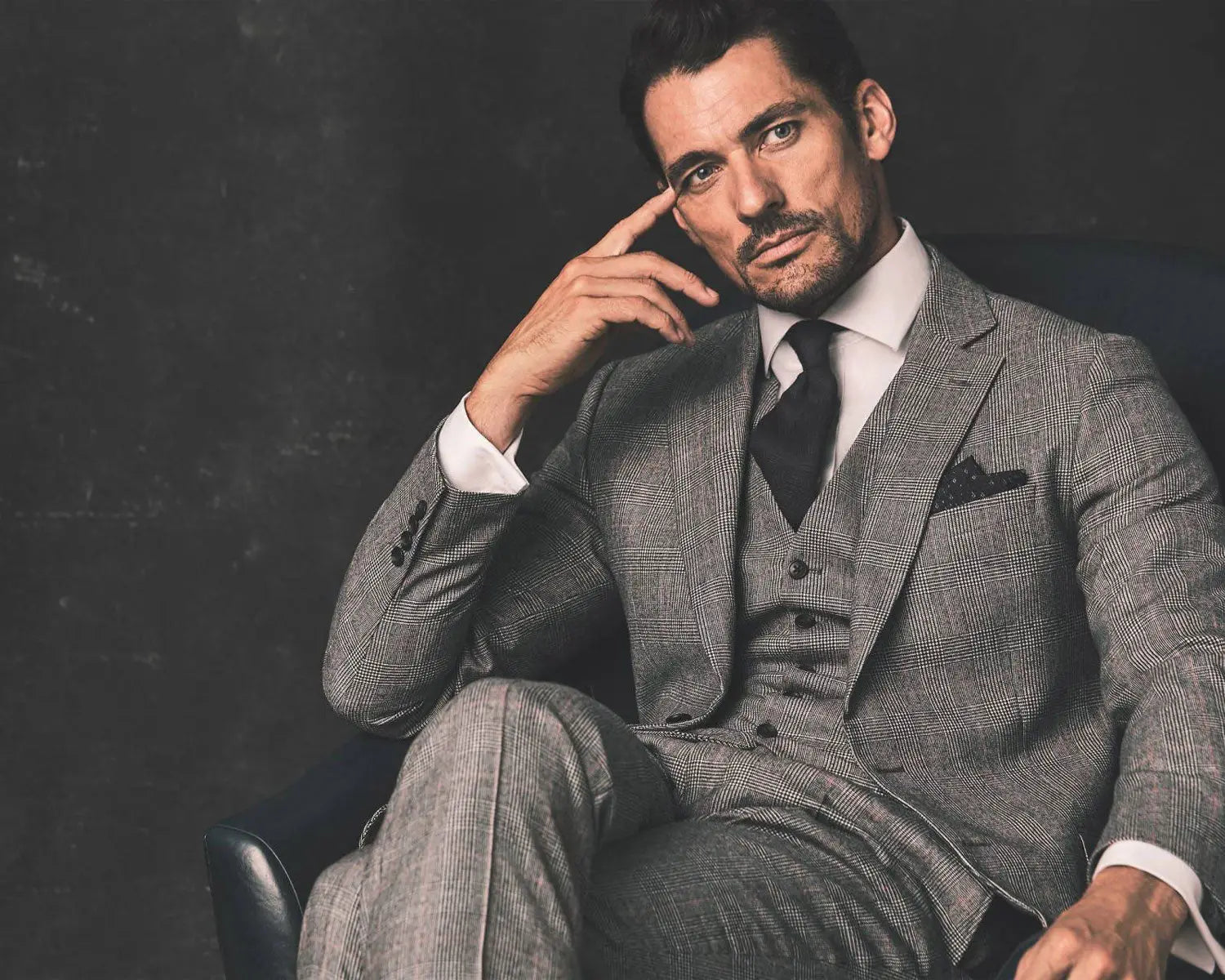 Man in a gray three-piece wedding suit with a dress shirt for the wedding day