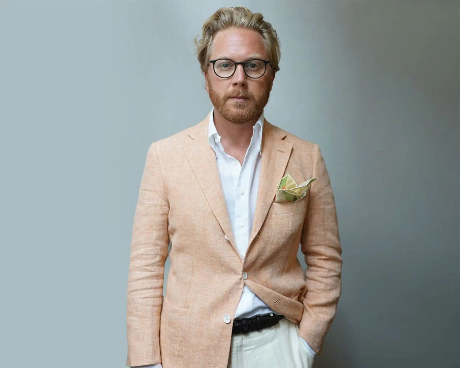 Man in peach blazer featuring a dress shirt, perfect for a wedding day wedding suit