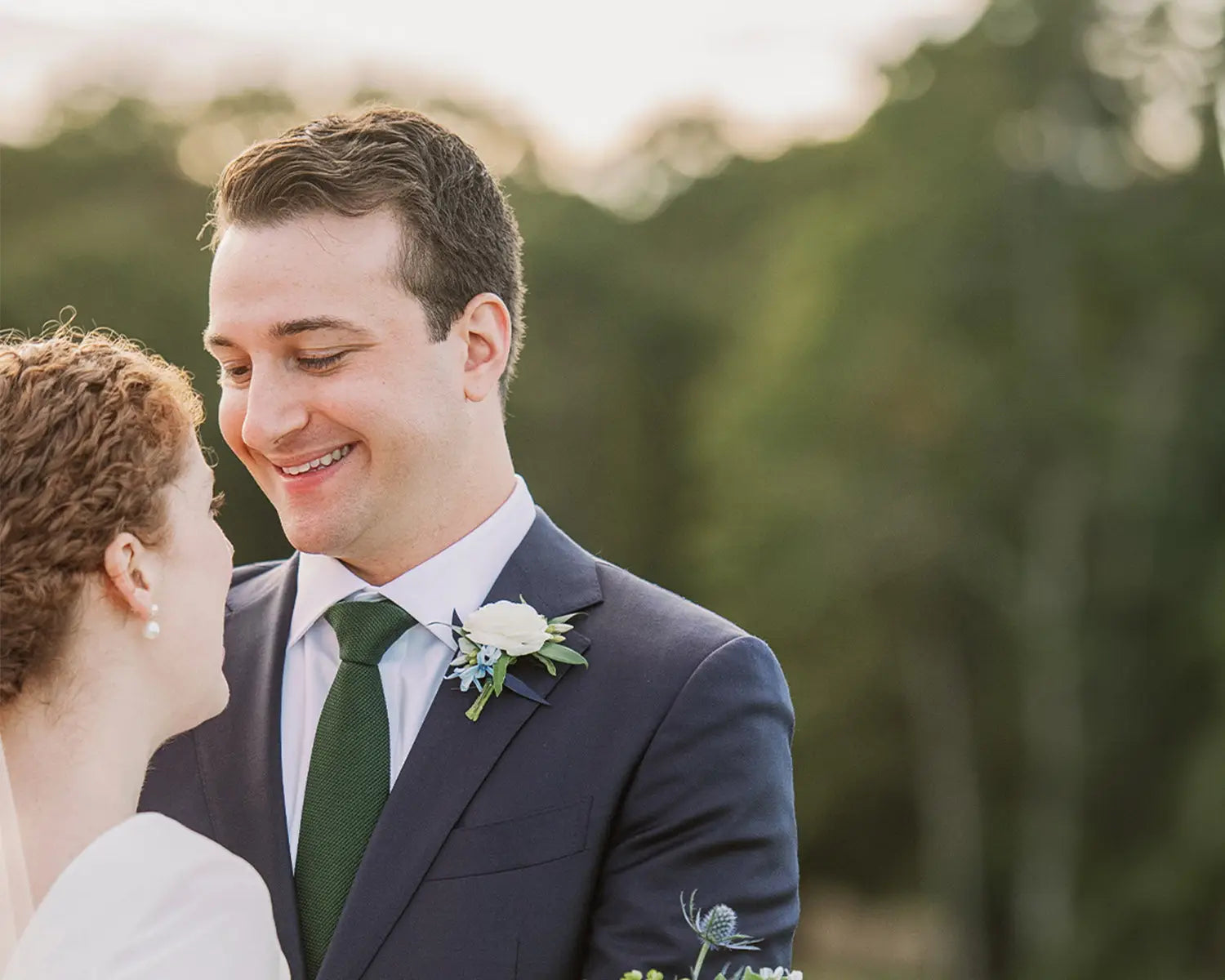 Smiling wedding couple in stylish wedding suits on their wedding day showcasing dress shirts