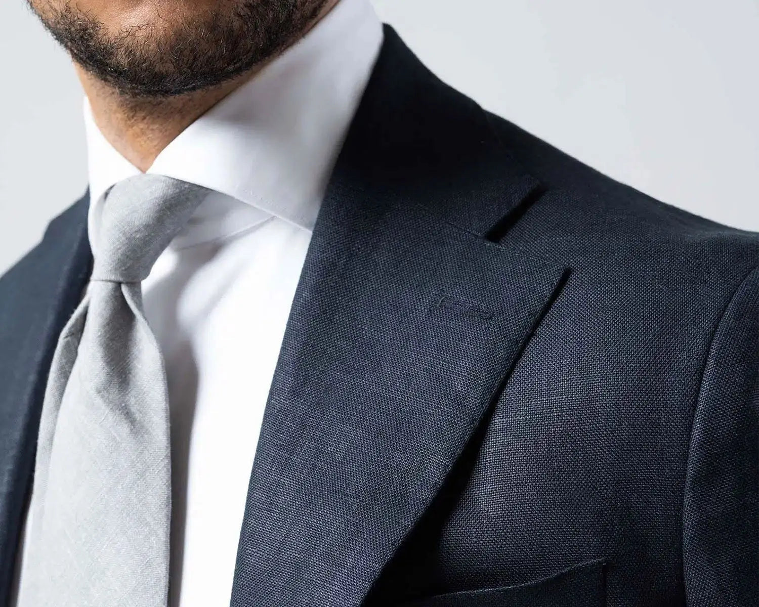 Dark suit with gray tie and dress shirt ideal for wedding day attire