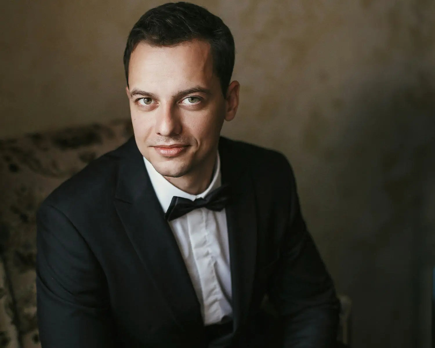 Man in black tuxedo with dress shirt, perfect for a wedding day wedding suit