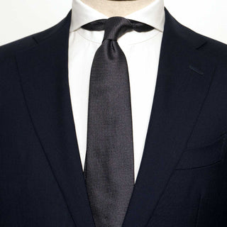 Charcoal Grenadine Tie styled with a navy suit and white shirt for a refined look.