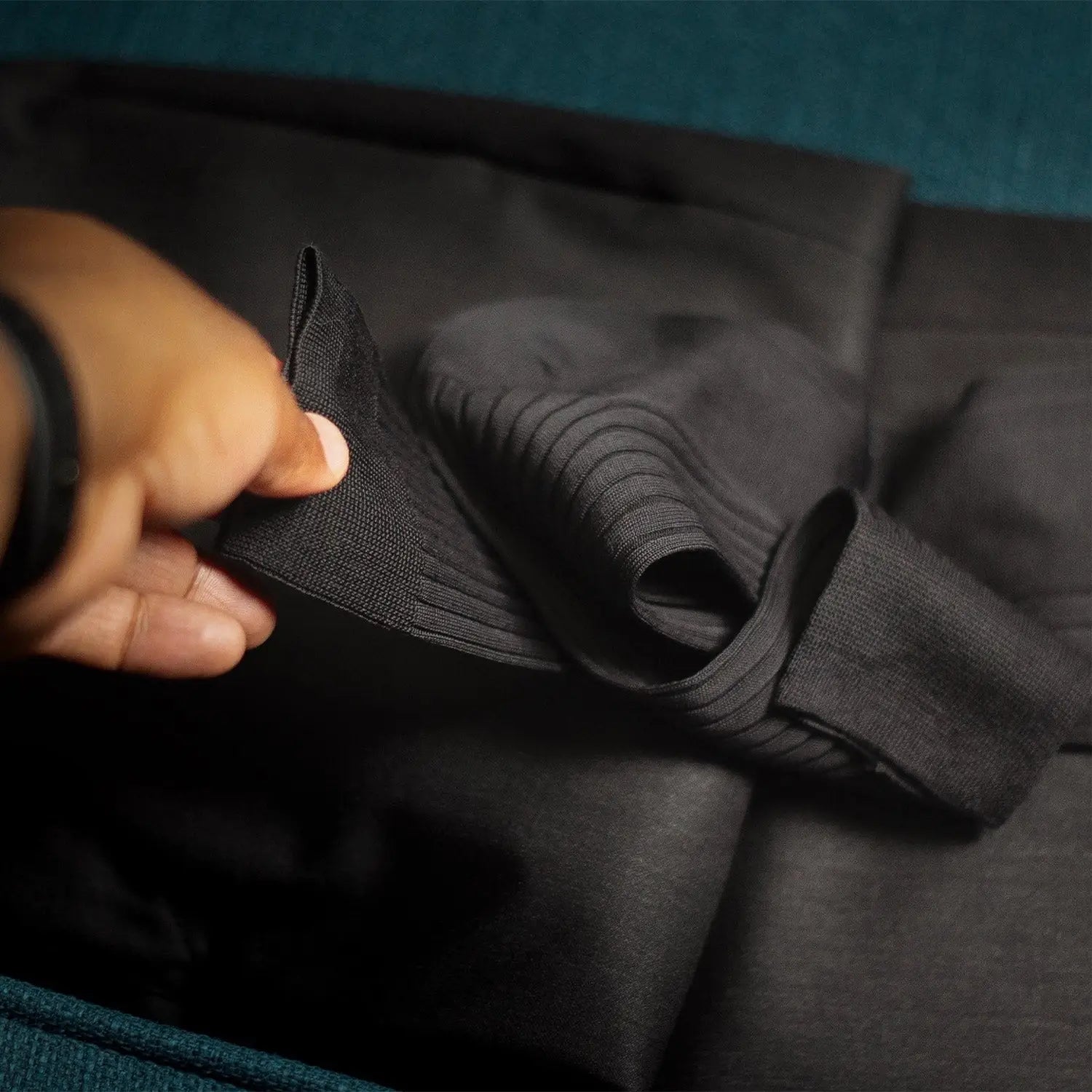 Folded black ribbed fabric showcasing quality clothes online for stylish buying clothes online