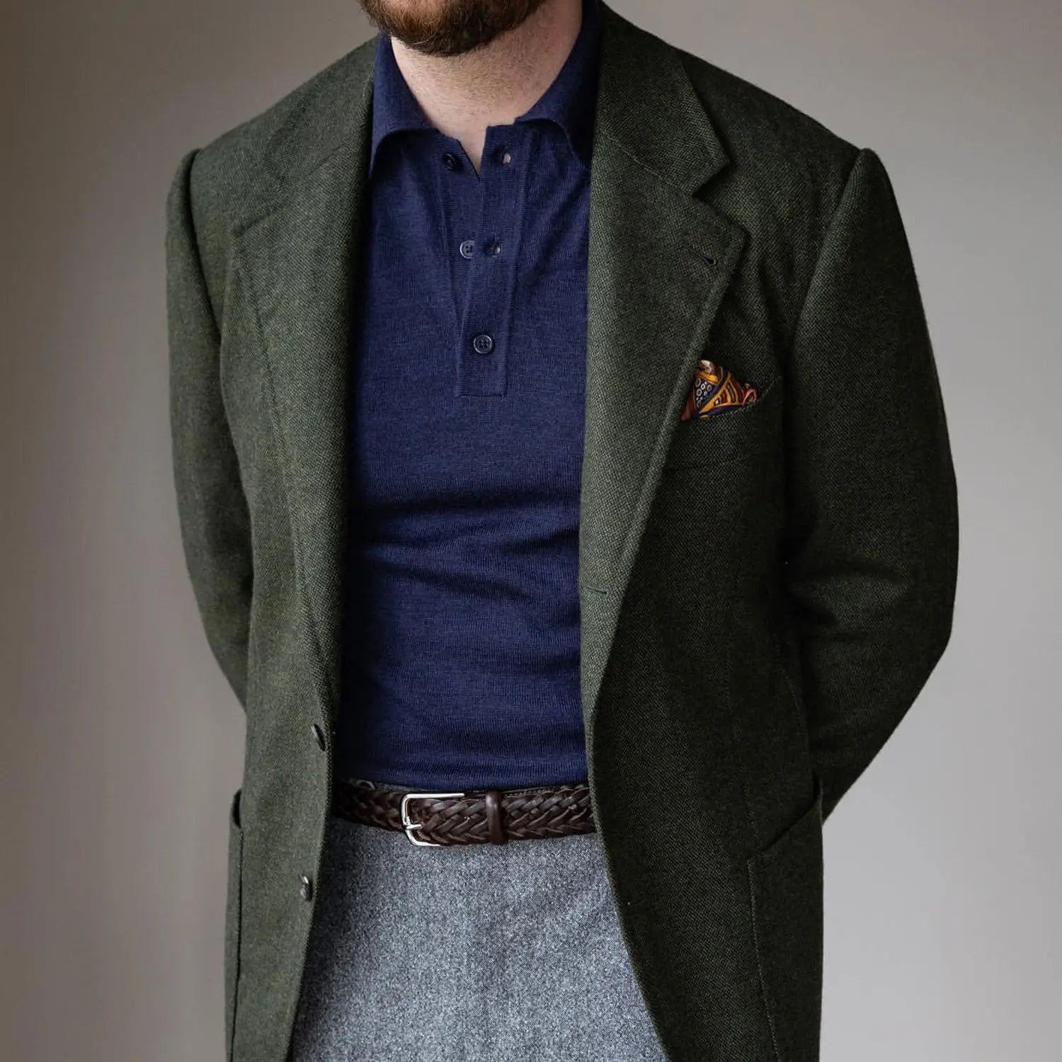 Man in green blazer and blue polo shirt demonstrating systems check for spotting a poor outfit