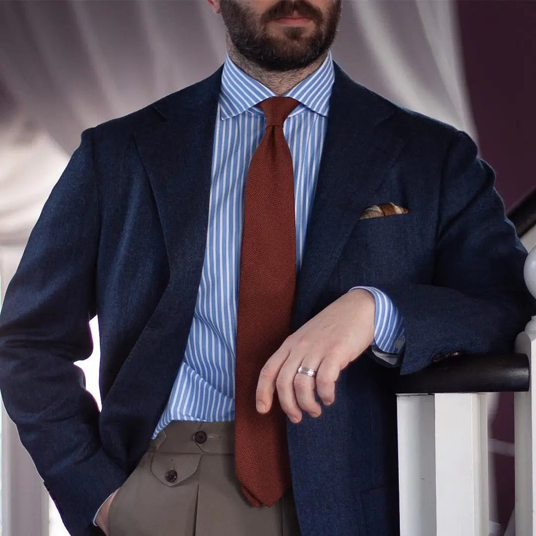 Man in blue suit with brown tie showcasing professional accountant outfits for client meetings at Australian Style Institute