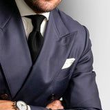 Black Grenadine Tie worn with a navy double-breasted suit and white pocket square