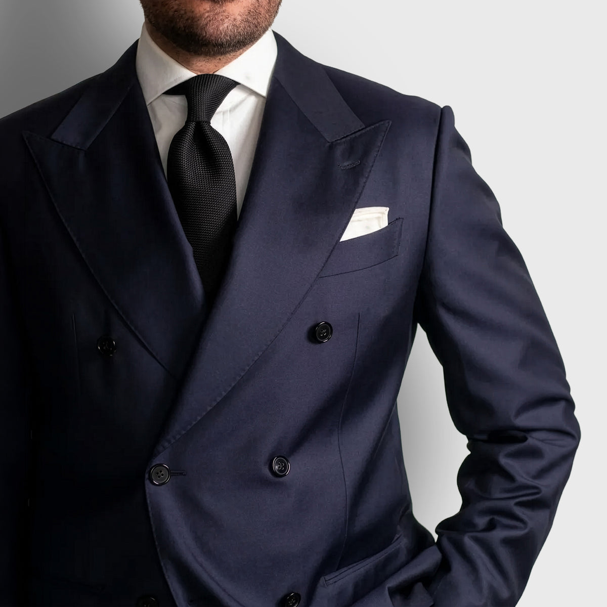 Black Grenadine Tie worn with a navy double-breasted suit and white shirt