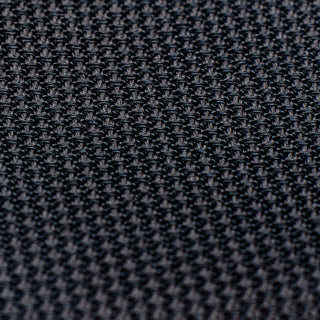 Detailed texture of black grenadine tie, emphasizing its intricate weave.