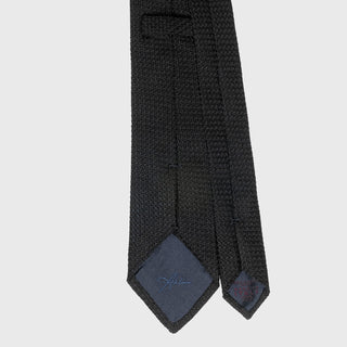 Close-up of the Black Grossa Grenadine tie's back detailing and label.