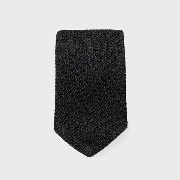 Black Grossa Grenadine tie in a flat, folded display showcasing its texture.