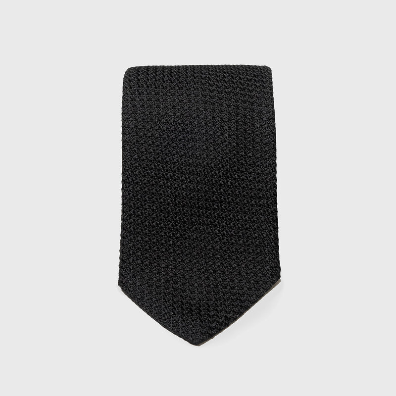 Black Grossa Grenadine tie in a flat, folded display showcasing its texture.