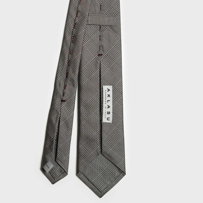 Back view of Glen plaid tie with detailed stitching and brand label.