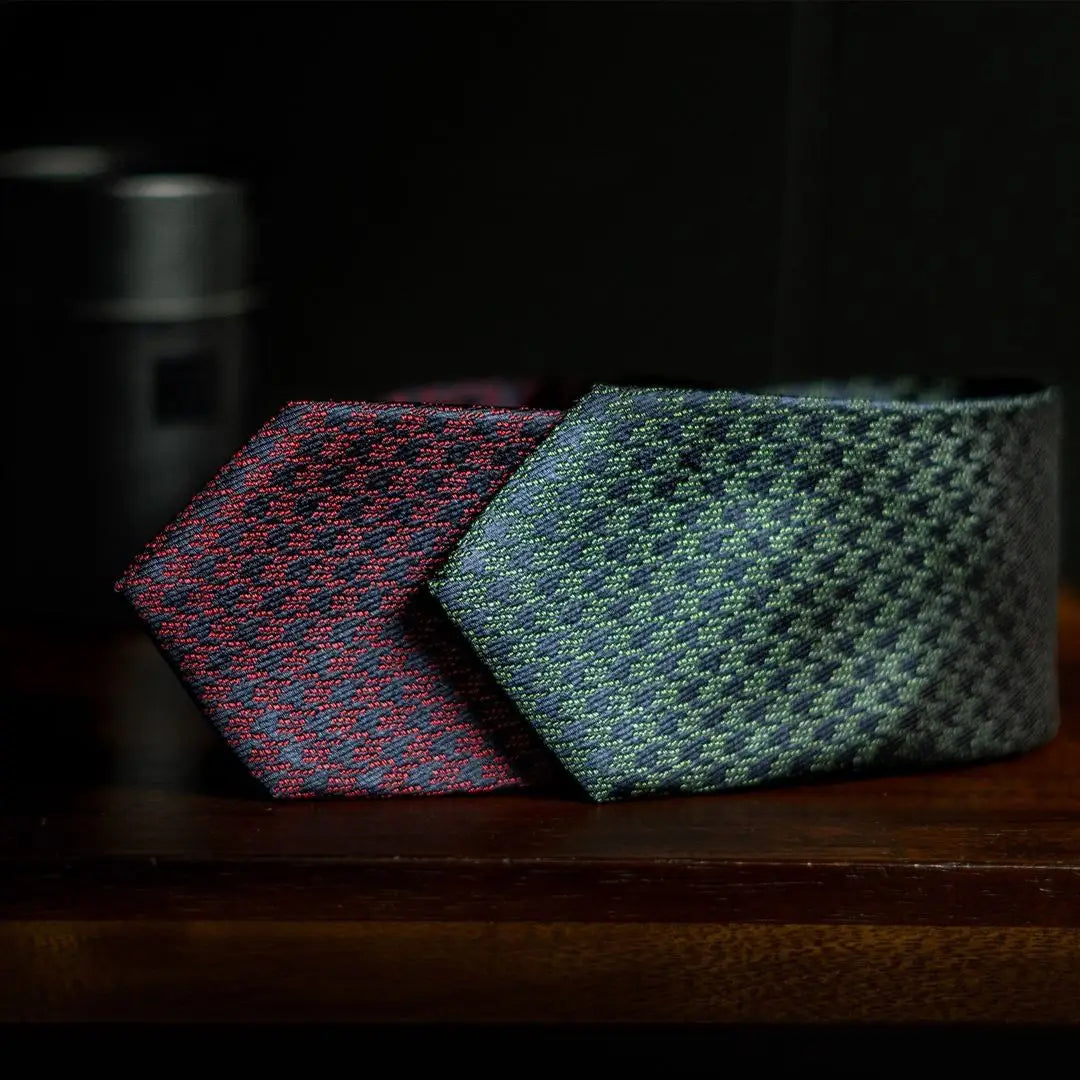 Two patterned neckties featuring navy houndstooth design for a sharp corner office look