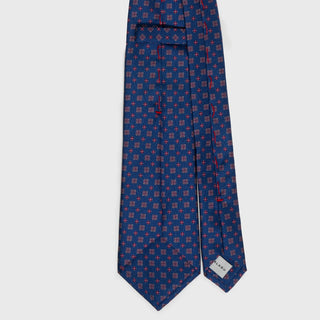 Back view of royal blue silk tie with floral foulard print and label detail.