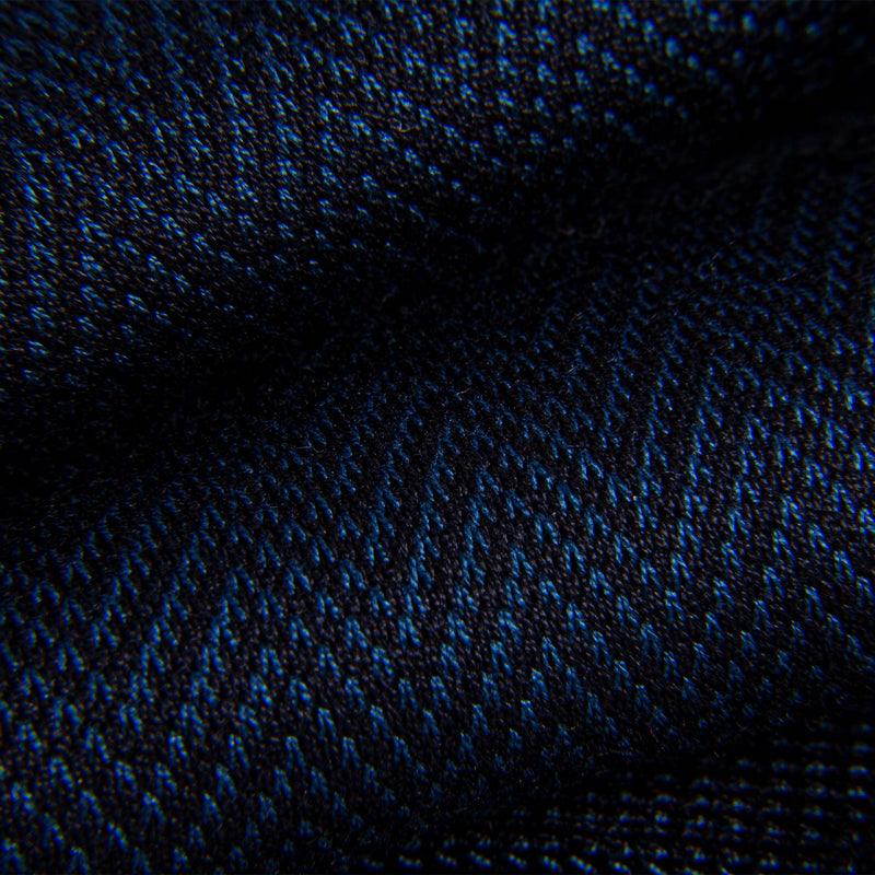 Close-up of blue and black chevron pattern on dress sock fabric.