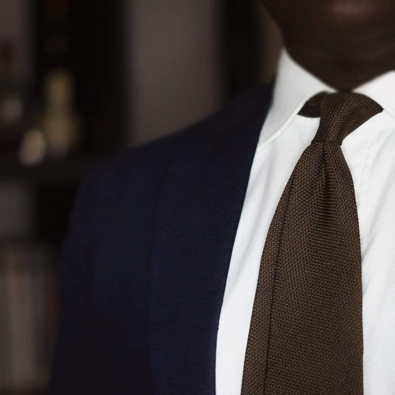 Brown Grenadine Tie styled with a white shirt and navy blazer, showcasing its elegance.