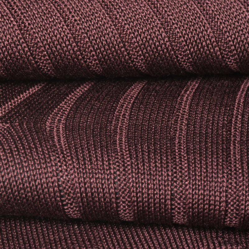 Close-up of burgundy dress sock showcasing ribbed texture and fine craftsmanship.