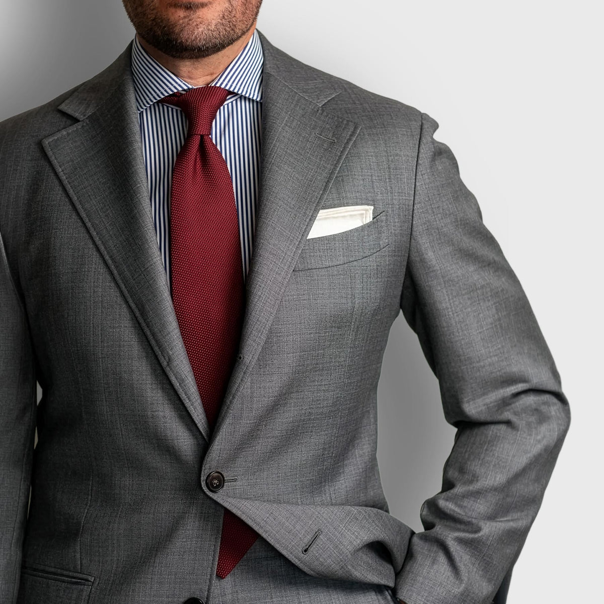 Burgundy Grenadine Tie worn with a grey suit and blue striped shirt