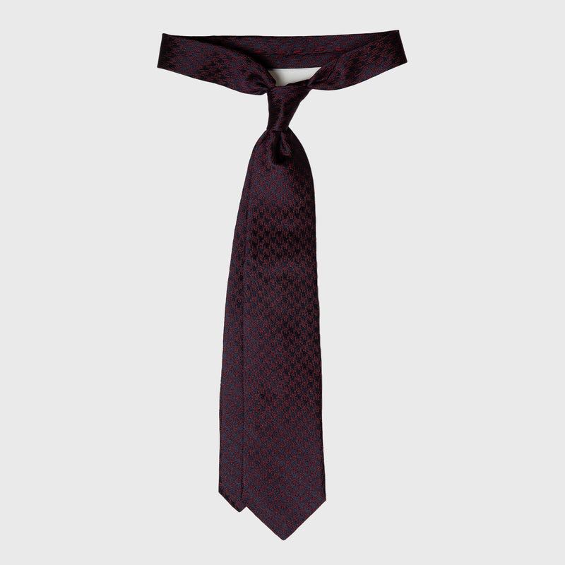 Burgundy and Navy Houndstooth Silk Tie tied in a classic knot.