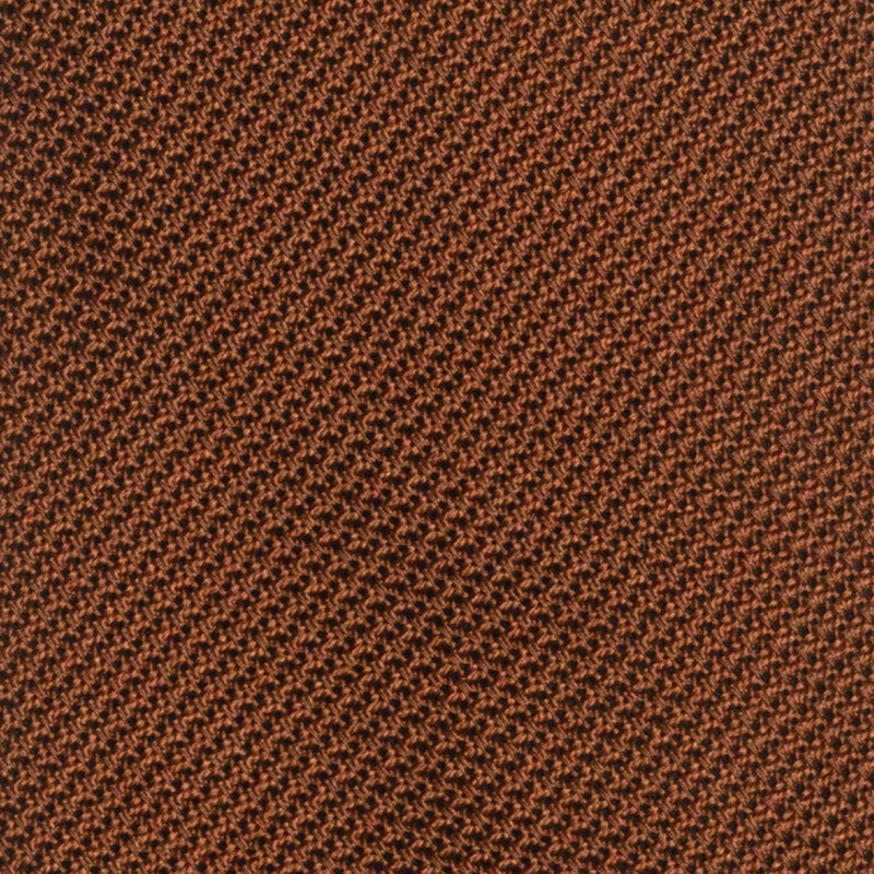 Close-up of burnt orange grenadine tie's intricate textured weave.