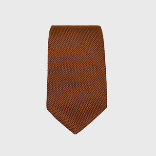 Burnt orange grenadine tie with a textured weave, displayed flat.