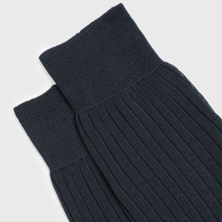 Pair of charcoal dress socks with ribbed design and over-the-calf fit.