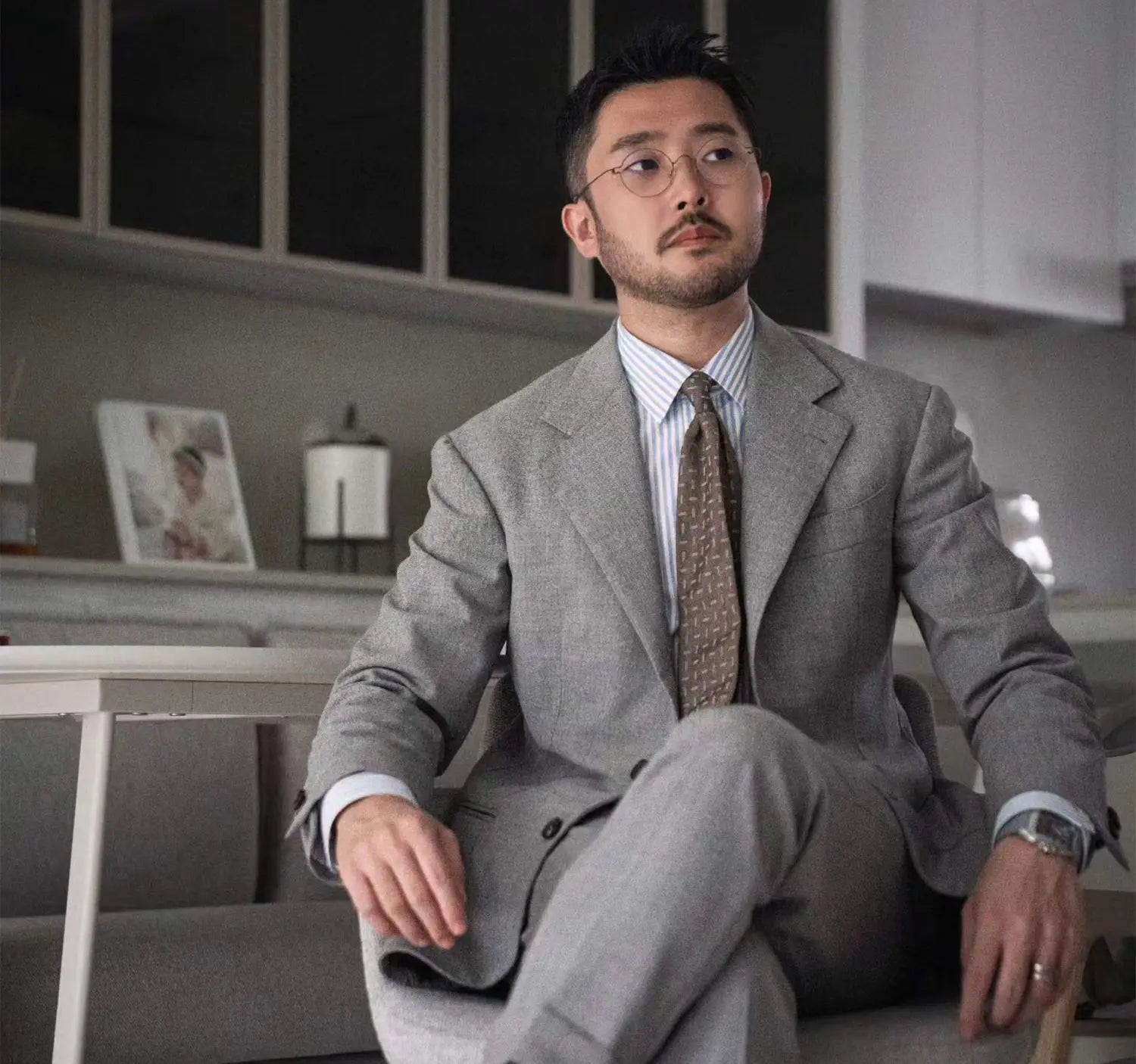 Well-dressed man in gray suit showcasing professional conference outfit for industry dress