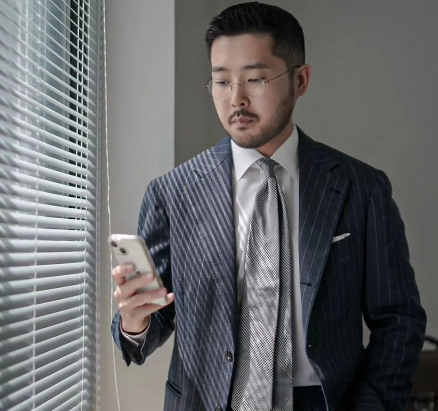 Well-dressed man using a smartphone in industry dress for conference outfits