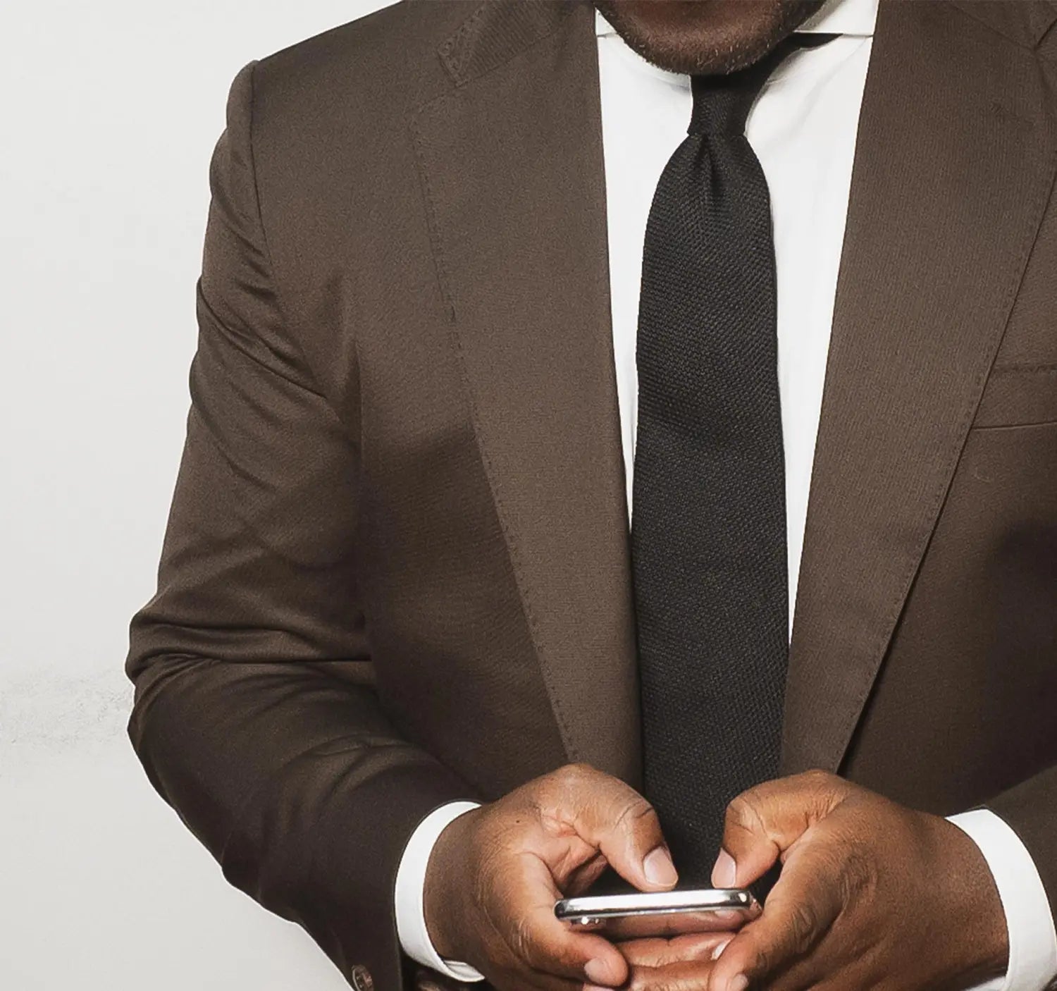 Brown suit with black knit tie, perfect conference outfit for industry dress