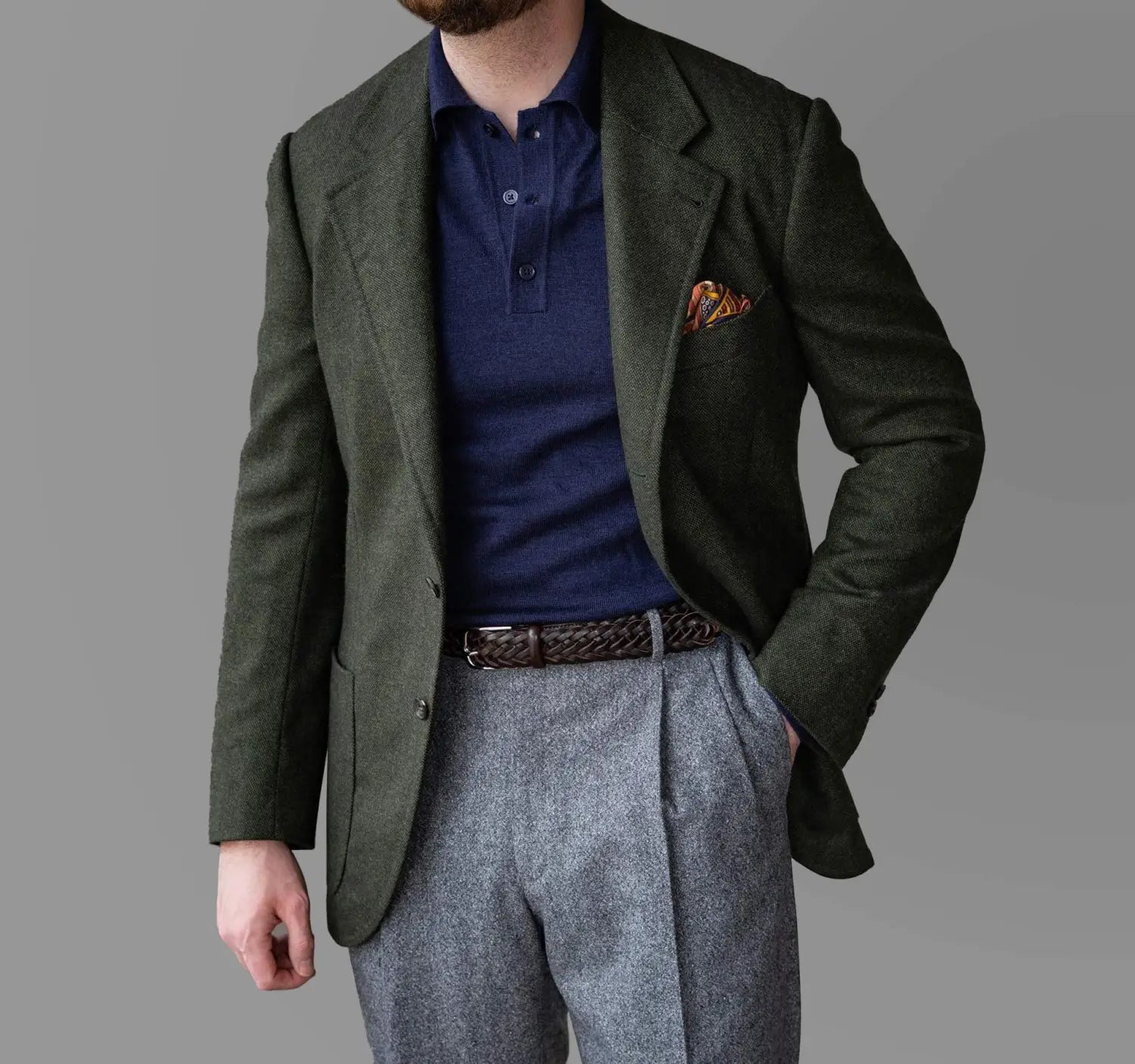 Man in blazer, polo, and trousers showcasing a professional conference outfit