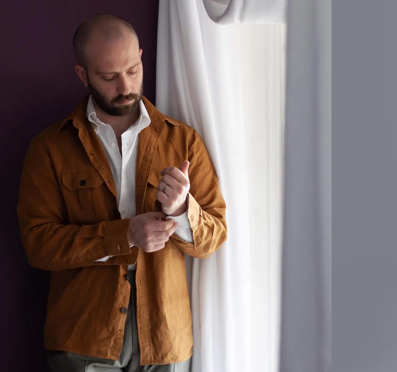 Man in brown shirt jacket showcasing a professional conference outfit for industry dress