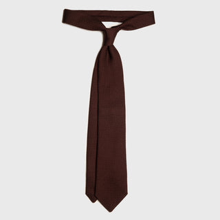 Deep Burgundy Grenadine tie tied in a classic knot, elegant design.