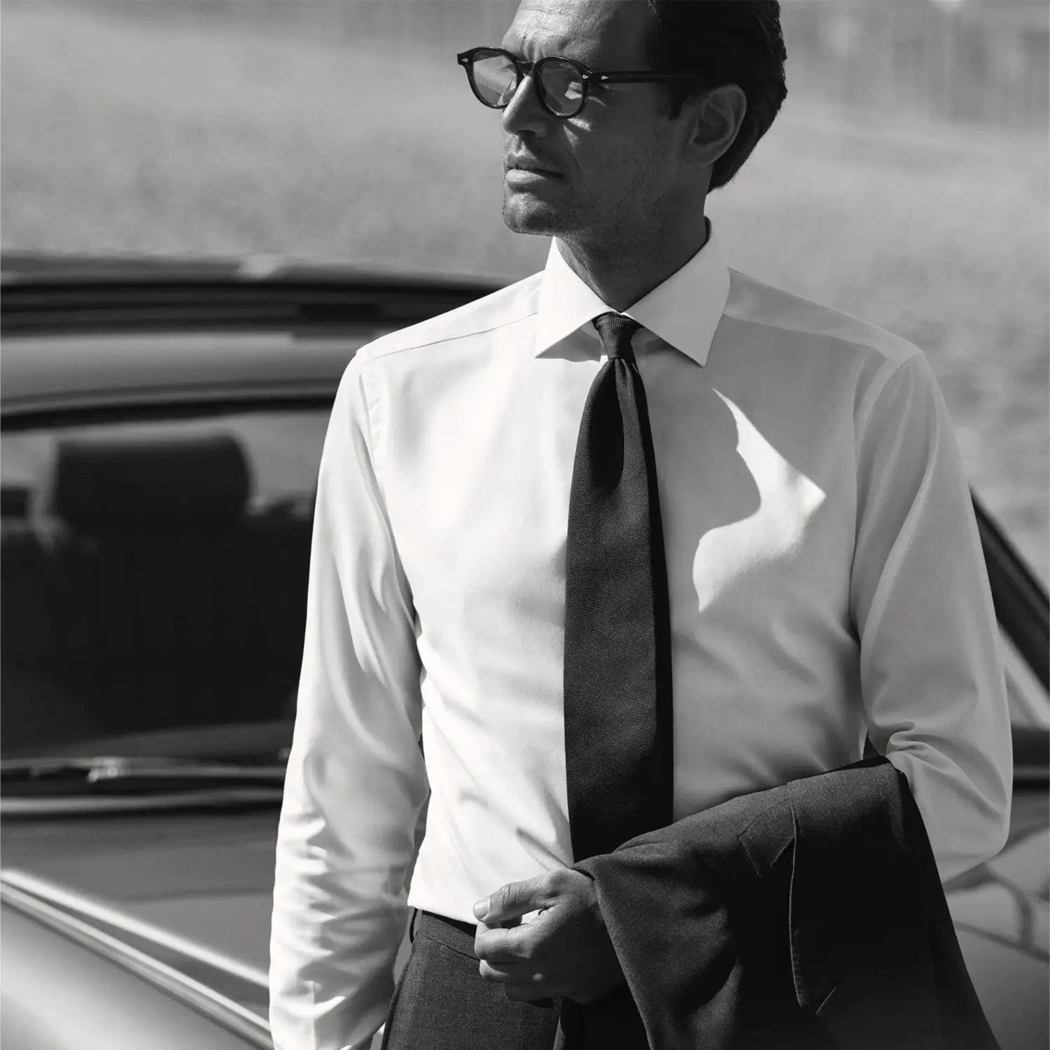 Well-dressed man in sunglasses showcasing elegant dress shirt fabrics for a sharp look