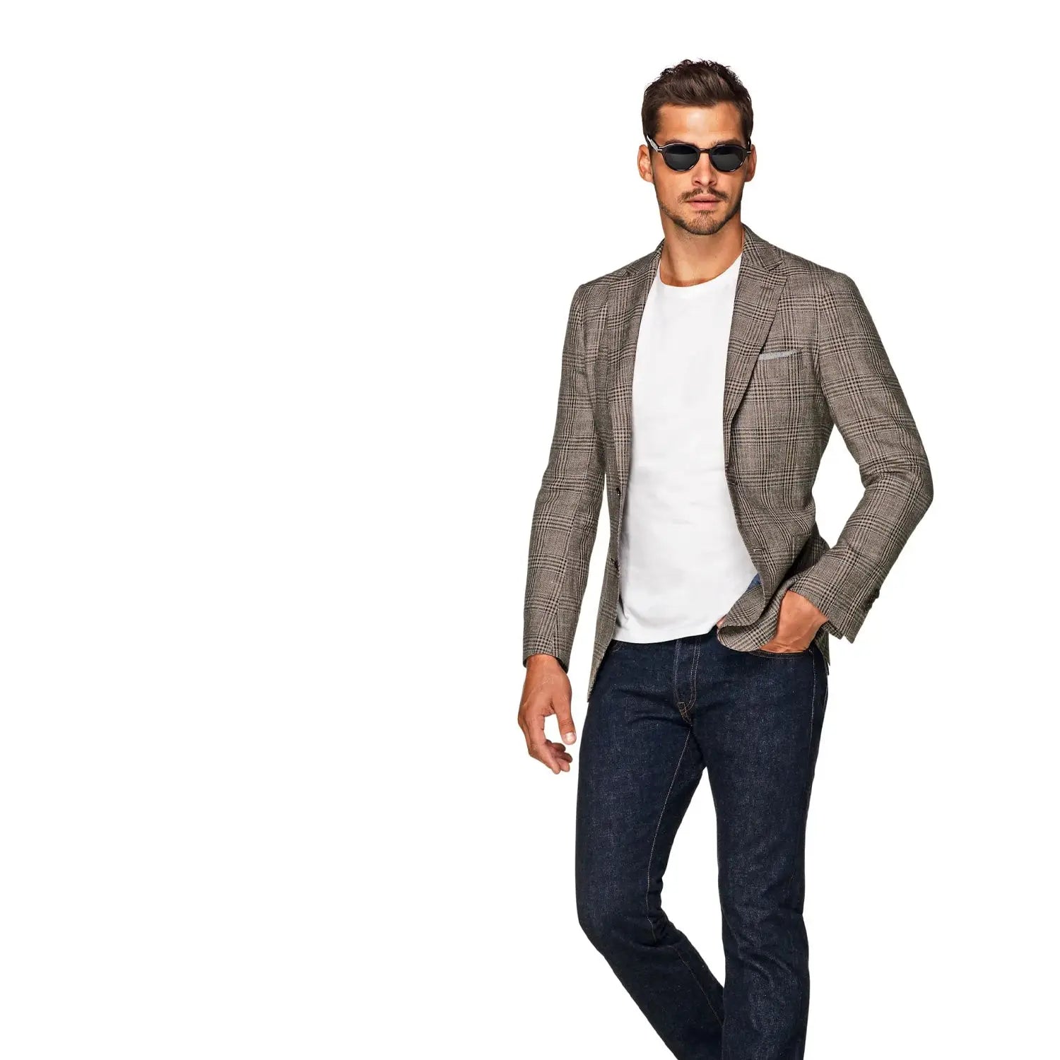 Man in blazer, t-shirt, and jeans showcasing elevated casual wear in neutral colours