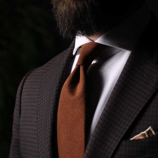 Burnt Orange Grenadine Tie with textured garza fina weave, made of 100% silk, worn with a suit.