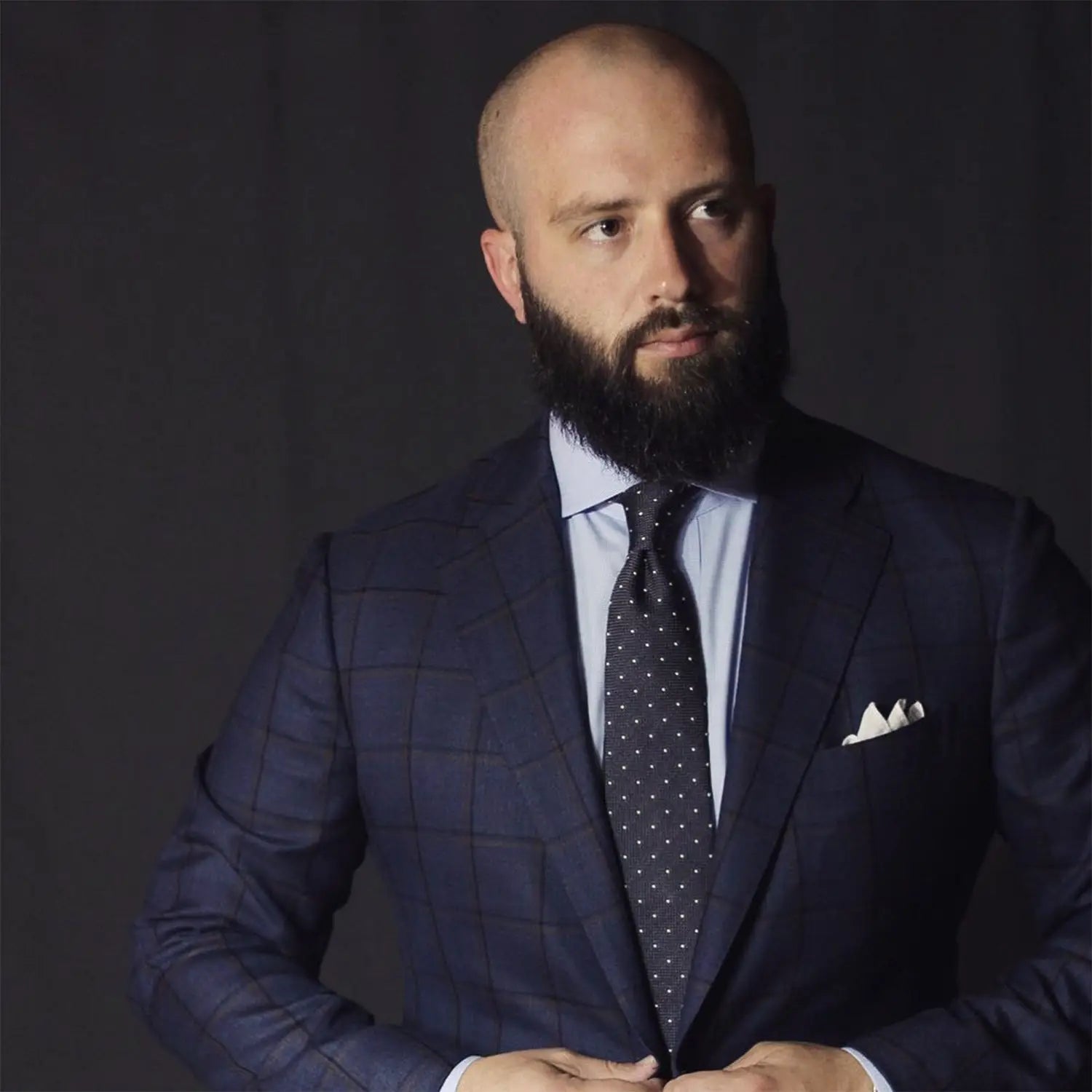 Well-dressed man in a grey suit showcasing professional outfits for realtors with curb appeal