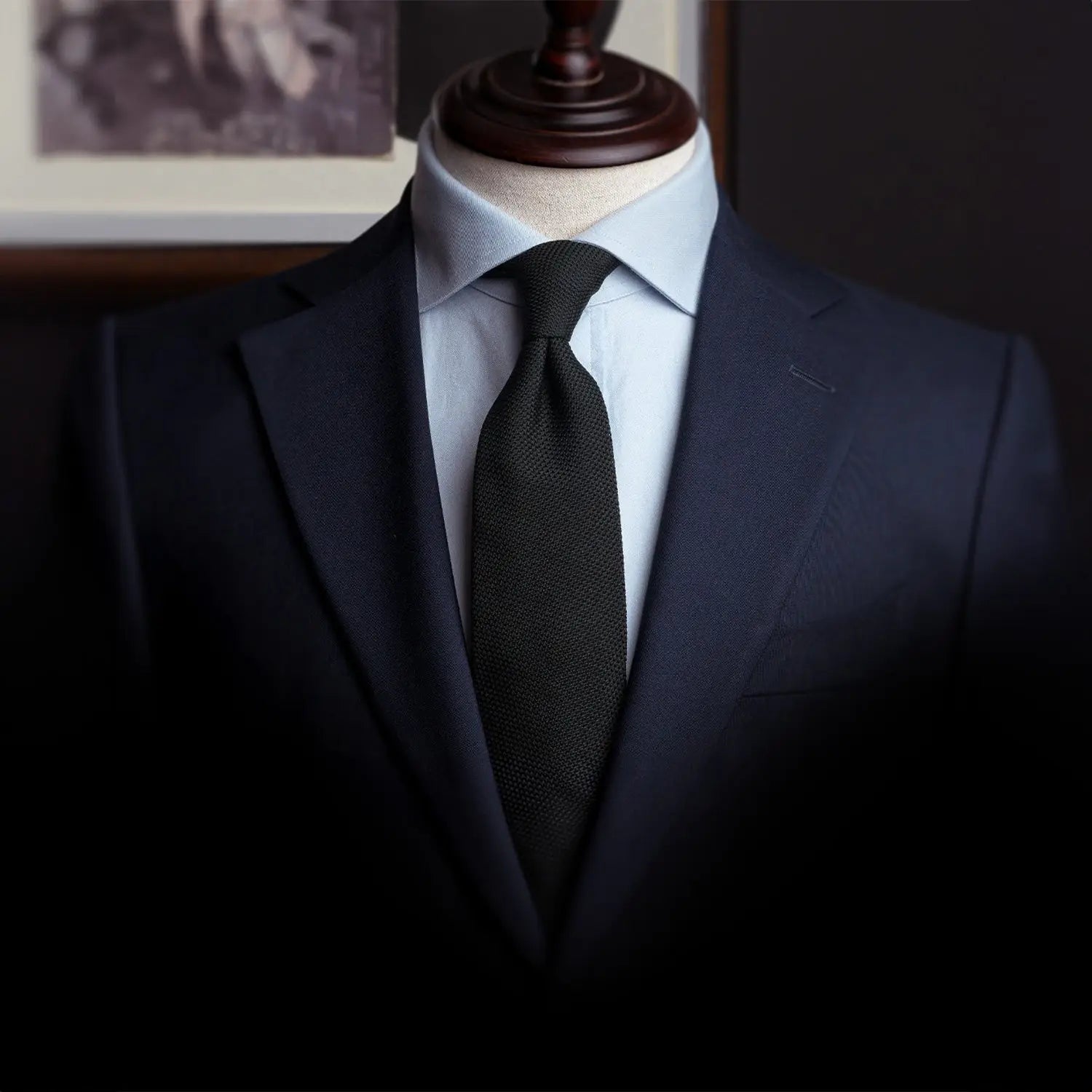 Navy suit with black knit tie showcasing a professional outfit for realtors
