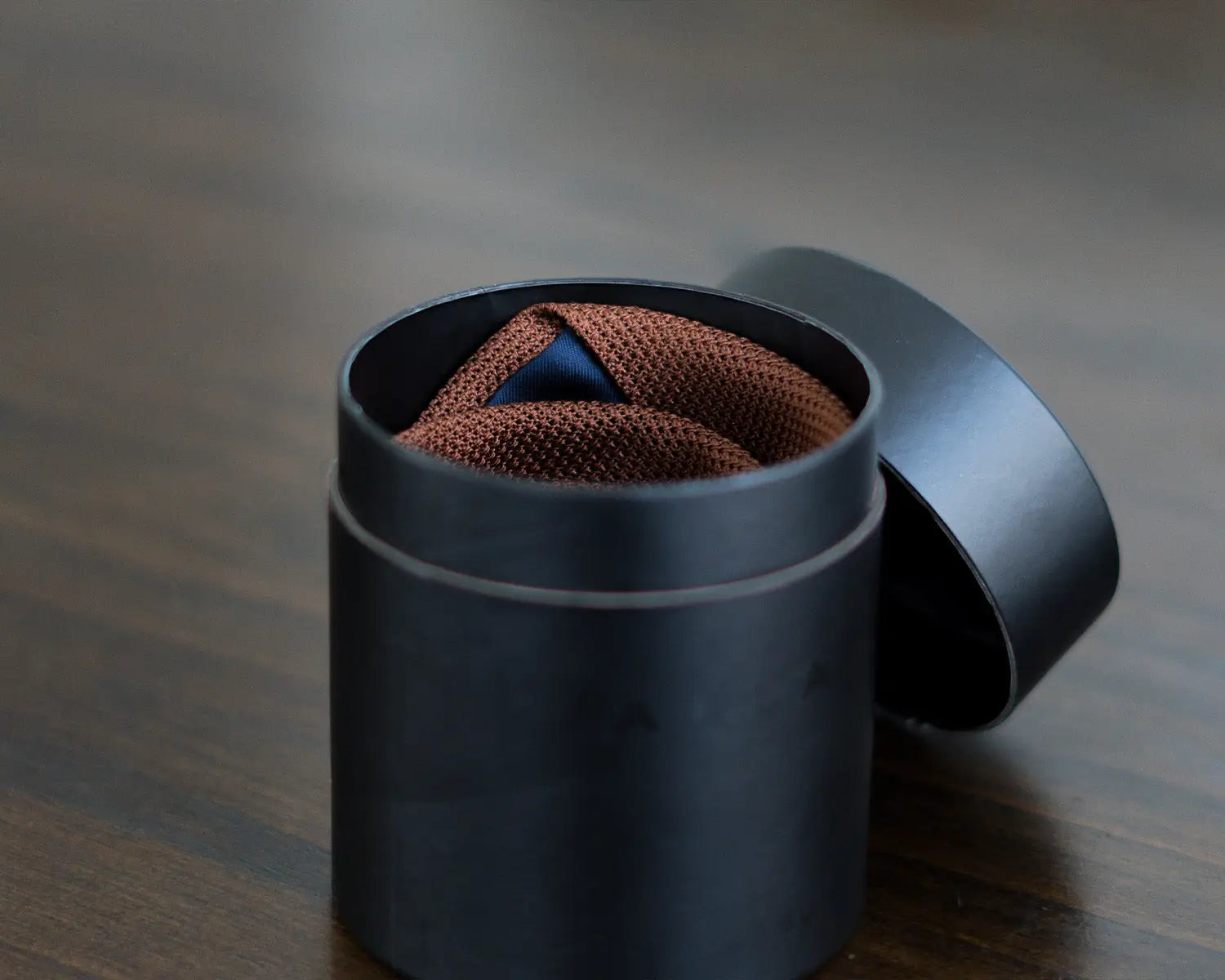 Burnt Orange Tie inside an Aklasu Canister