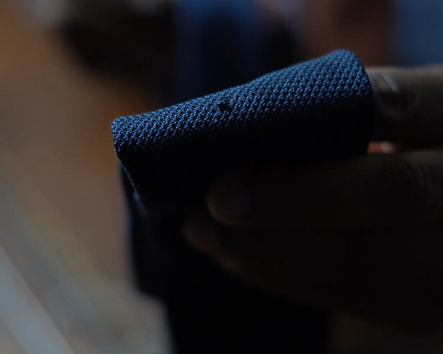 Dark blue textured fabric suitable for repairing a striped grenadine tie with a grey suit