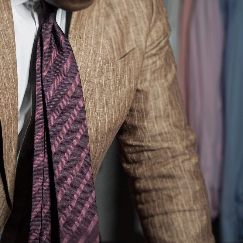 Maroon Grenadine Tonal Stripe Tie styled with a beige suit for a sophisticated look.