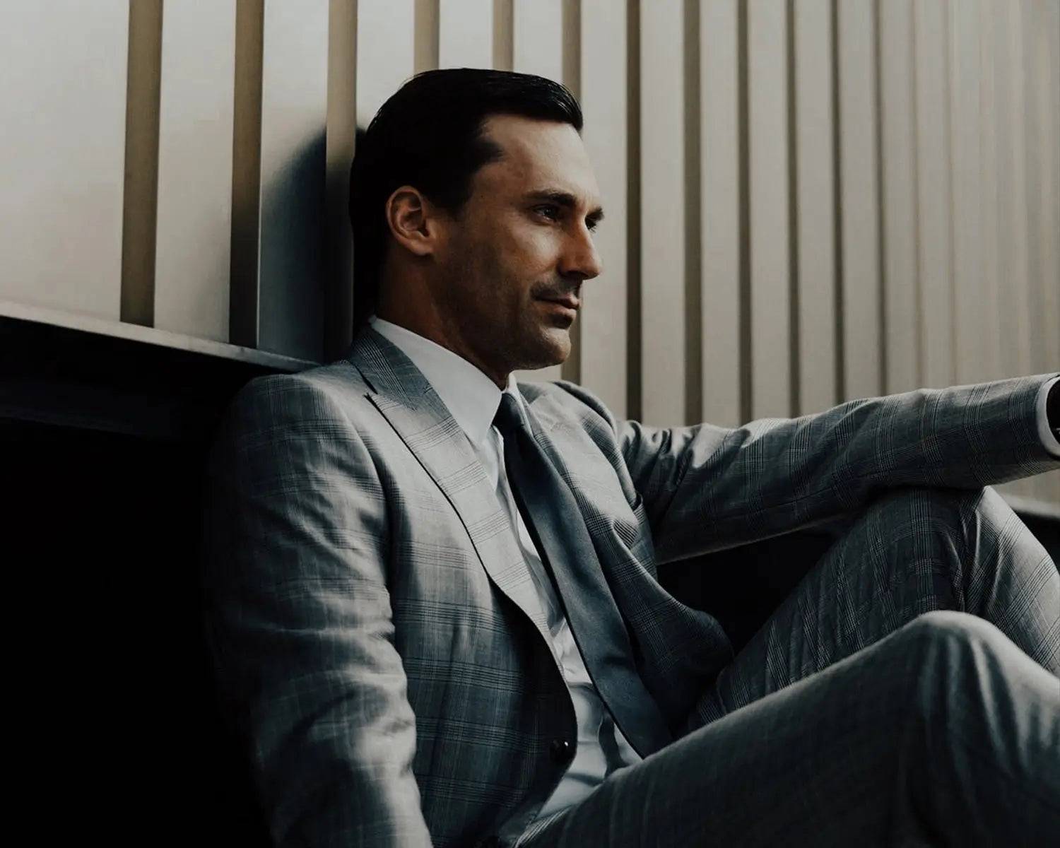 Man in gray suit exemplifying timeless styling and natural materials in post-COVID-19 pandemic fashion