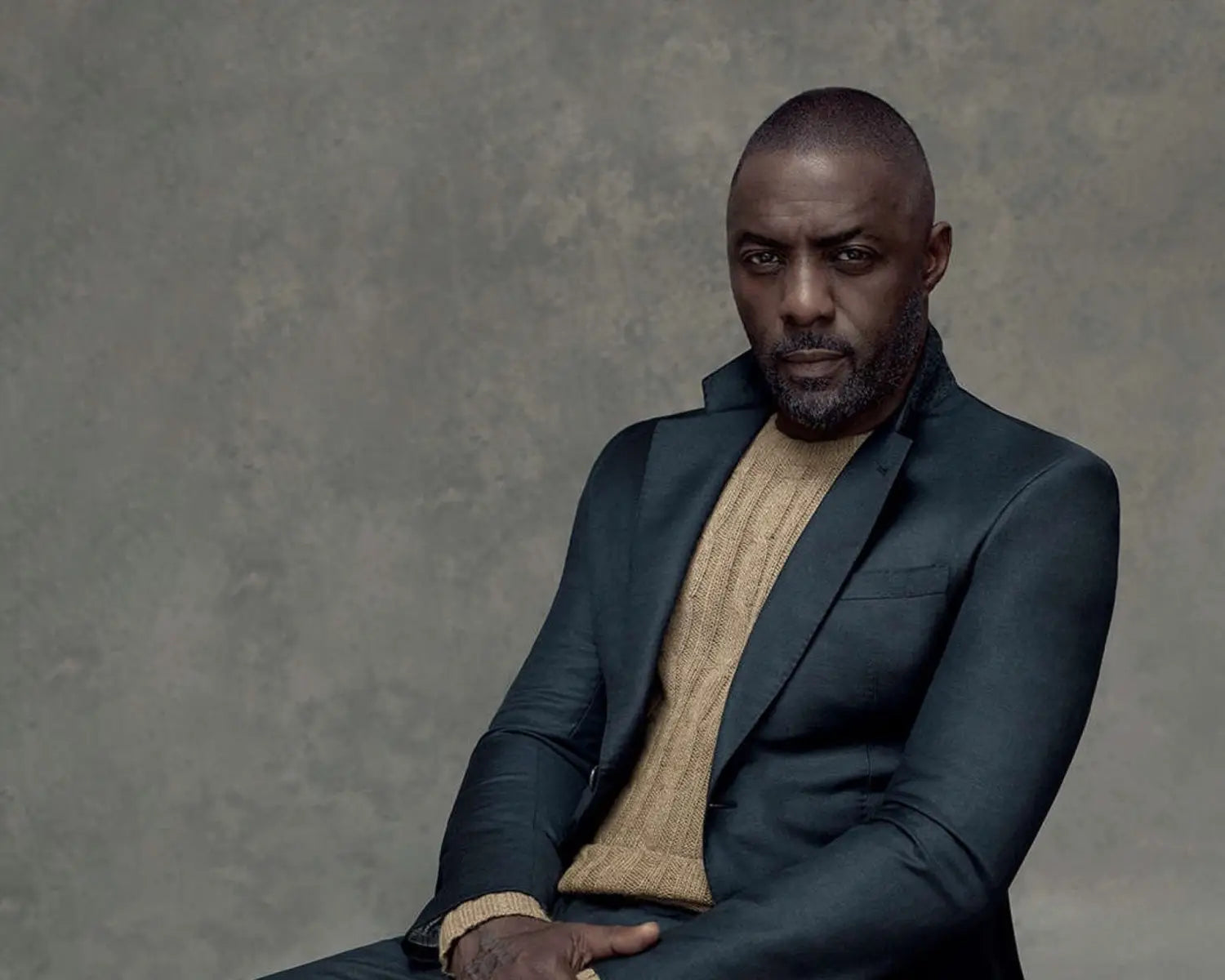 Idris Elba in a suit showcasing timeless styling with natural materials post Covid-19 pandemic