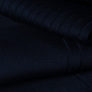 Close-up of dark blue dress sock fabric showcasing fine ribbed texture.