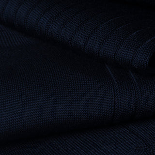 Close-up of dark blue ribbed cotton fabric for dress socks.