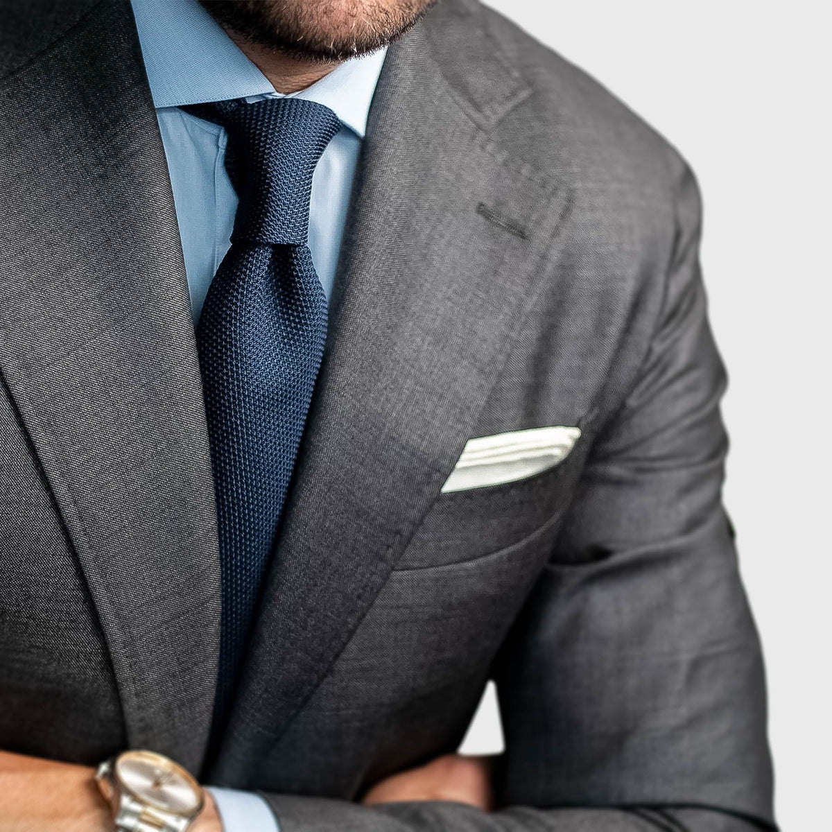 Navy Grenadine Tie worn with a grey suit, light blue shirt and white pocket square