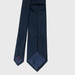 Back view of Navy Grenadine Tie with detailed stitching and label.